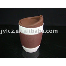 white ceramic mug with silicone sleeve and lid